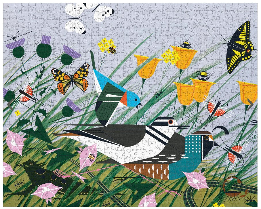 A completed 1000-piece puzzle featuring the artwork of Charley Harper with a vibrant depiction of birds, flowers, and insects in a field.
