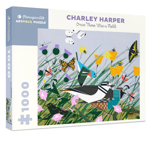 A 1000-piece puzzle box featuring the artwork of Charley Harper with a vibrant depiction of birds, flowers, and insects in a field.