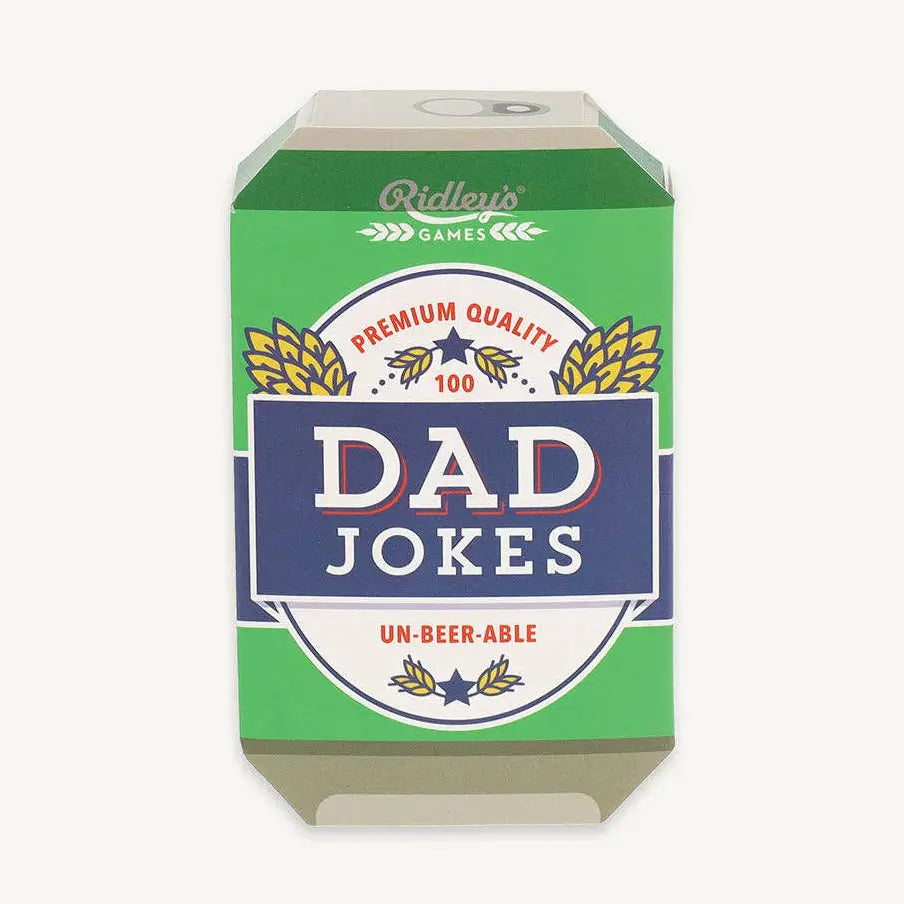 A 3D box for a card game titled 'Dad Jokes' by Ridley's Games. The packaging features a green background with a central navy blue banner containing the white text 'DAD JOKES', flanked by white circular badges and gold wheat illustrations.
