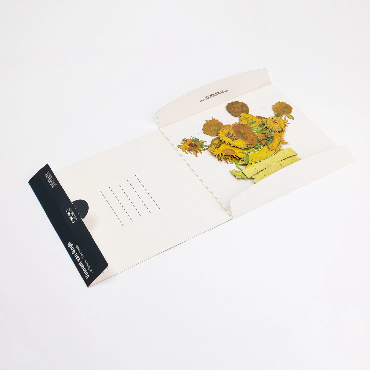 Open card with floral design and black card on a white background