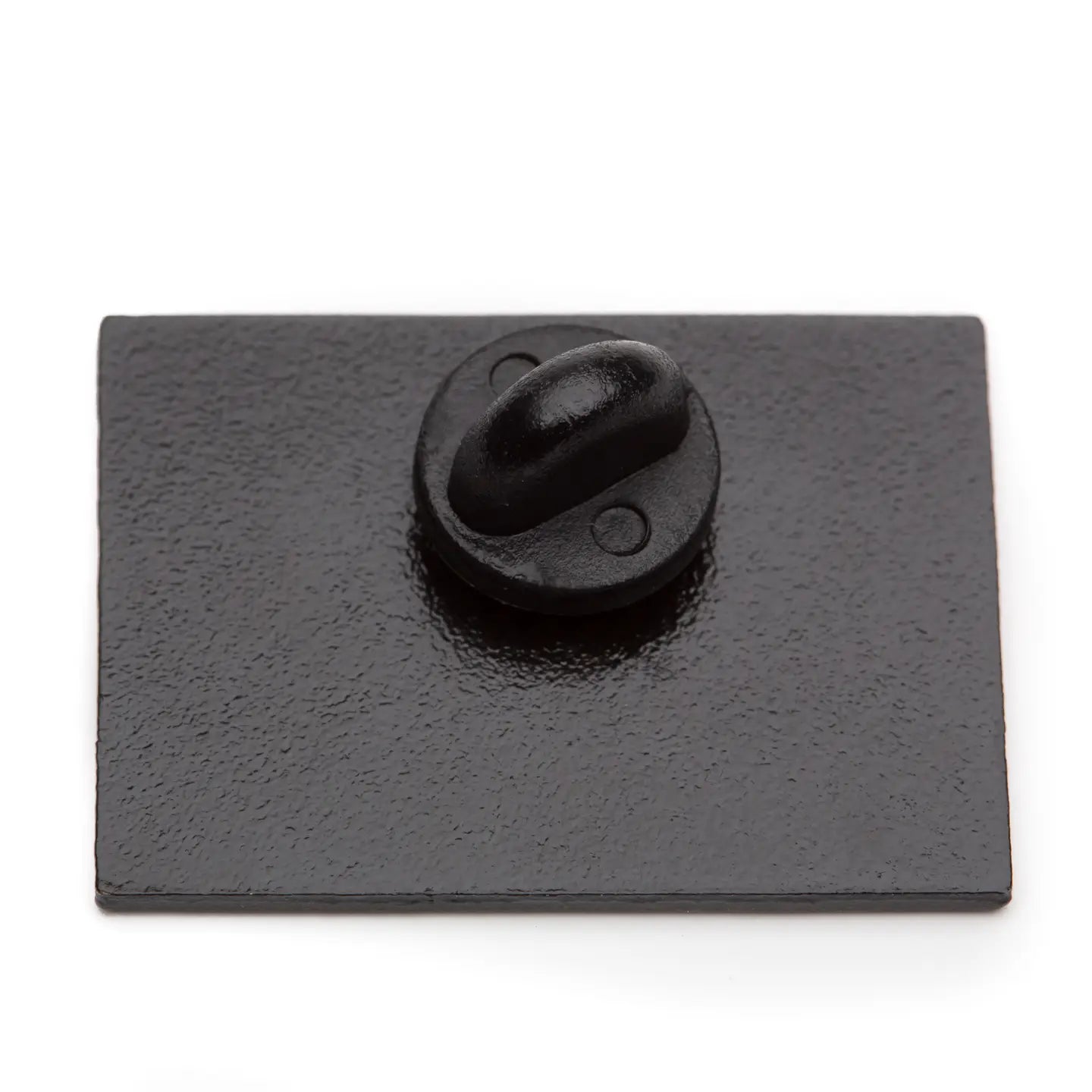 Black rectangular metal plate with a central pin back on a white background