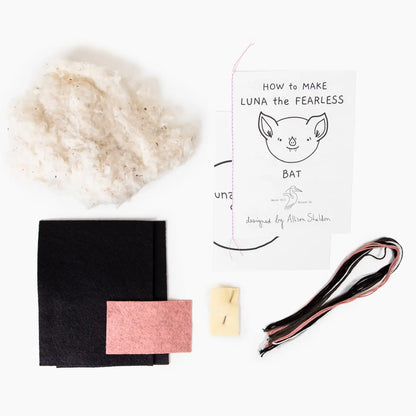 Toy-making kit with materials, instructions, and an illustration of a bat on a white background
