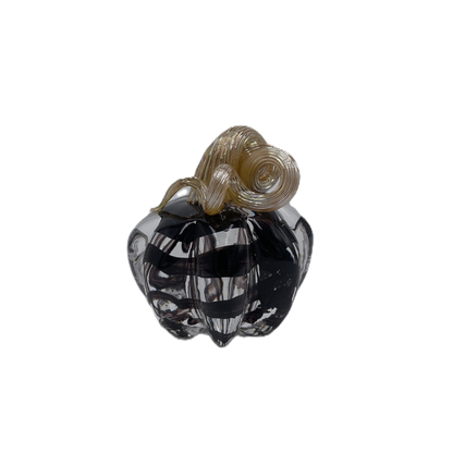 A small glass pumpkin with a dark smoky black body and a twisted tan stem, isolated on a white background.