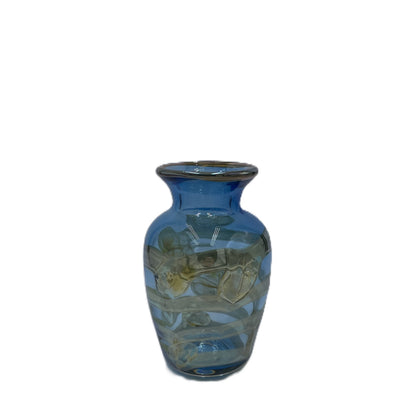 Blue glass vase with an irridescent floral design on a white background