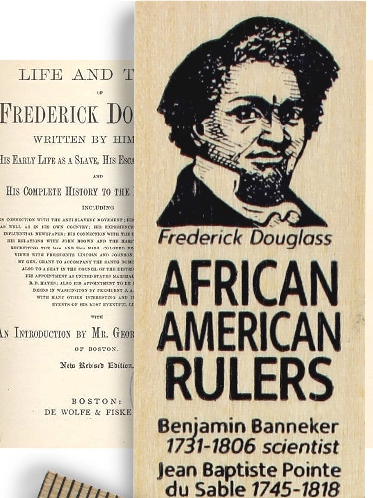 A wooden ruler featuring a black-and-white portrait of Frederick Douglass on the right and a partial view of a printed book page on the left, with large text reading 'Frederick Douglass African American Rulers' and additional names at the bottom.
