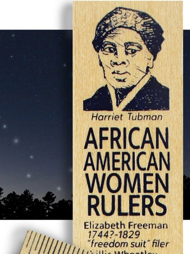 A ruler featuring an engraved portrait of Harriet Tubman and the text 'AFRICAN AMERICAN WOMEN RULERS' with additional names and text below, shown against a dark night-sky background with a partial second wooden ruler visible at the bottom.