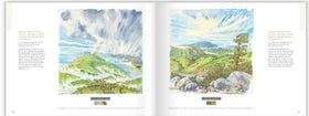 An open book with watercolor illustrations of a landscape with trees and mountains.