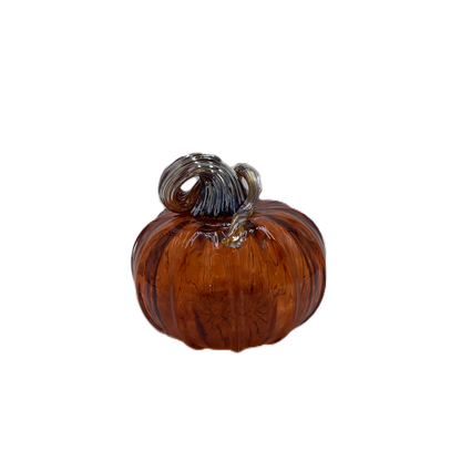 A small decorative glass pumpkin ornament in amber brown with a textured, ribbed surface and a metallic silver-gray wrapped stem, isolated on a white background.