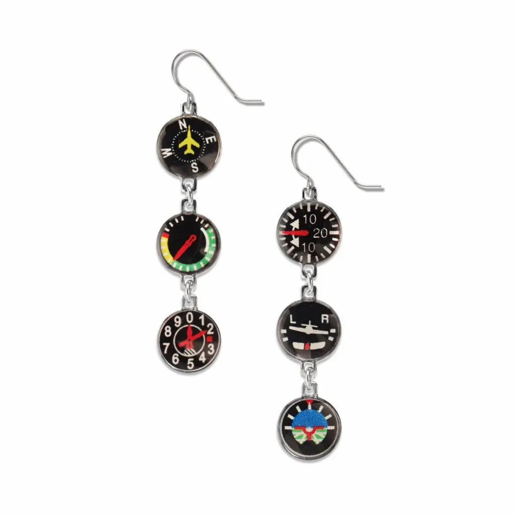 Pair of earrings with aviation-themed dials on a white background