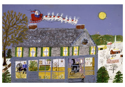 A blue house in a winter landscape with Santa and his reindeer flying over the roof.