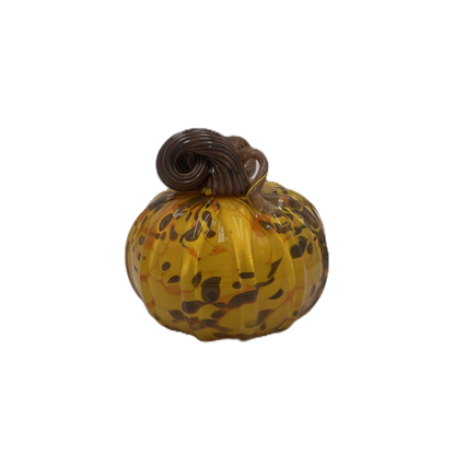 A small decorative glass pumpkin with a marbled amber-yellow body, dark brown and orange speckles, and a dark brown stem, isolated on a white background.