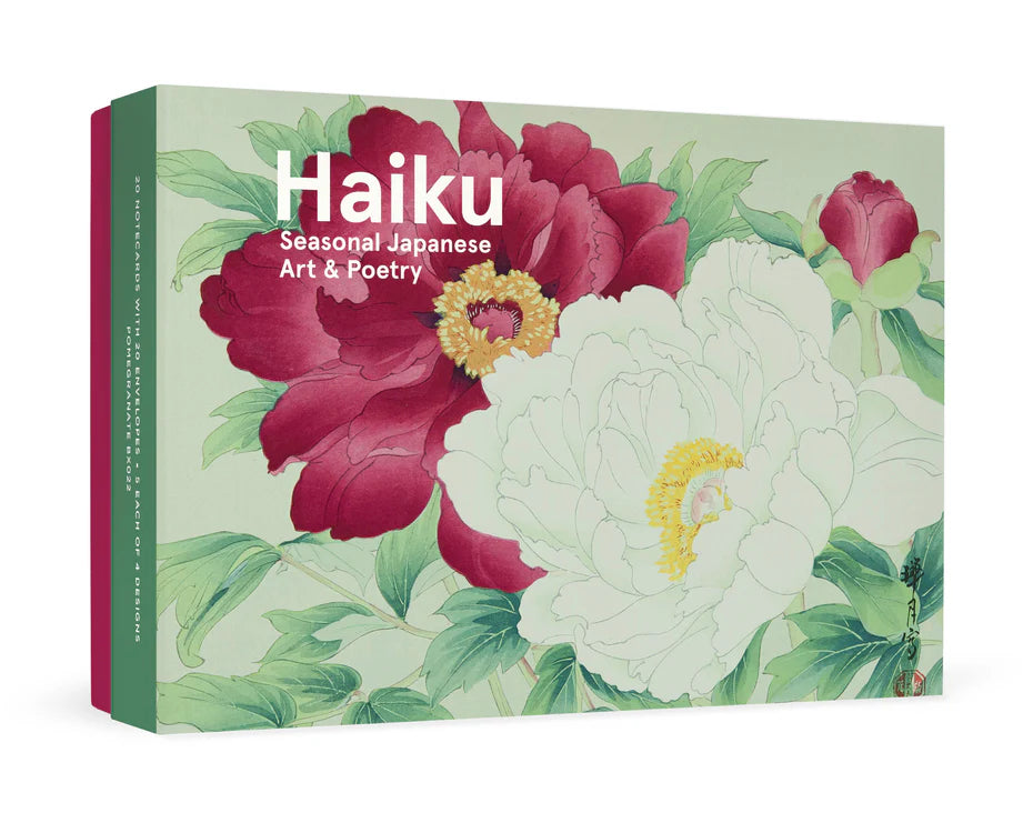 A box of notecards titled 'Haiku: Seasonal Japanese Art & Poetry' with a pink, white, yellow, and green floral design on the cover