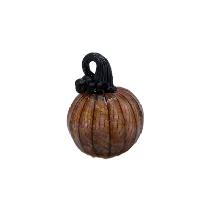 A small decorative glass pumpkin with a ribbed body, amber-orange marbling, and a black stem, isolated on a white background.