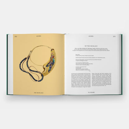 Inside of a book featuring a photograph of a metal and beaded necklace