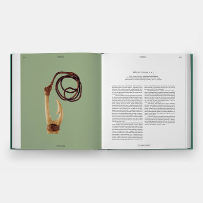 Inside of a book featuring a carved bone fishhook on a leater cord on a green background.