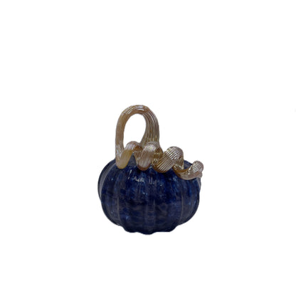 A small decorative glass pumpkin figurine with a deep blue body and a twisted, ribbed handle in a pale amber-tinted glass, isolated on a white background.