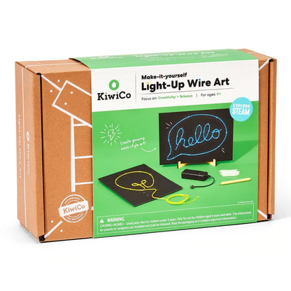 Product packaging with the words "Kiwi Co. Make-it-yourself Light-Up Wire Art". Bowrn box with a green band showing two black signs with wire art.