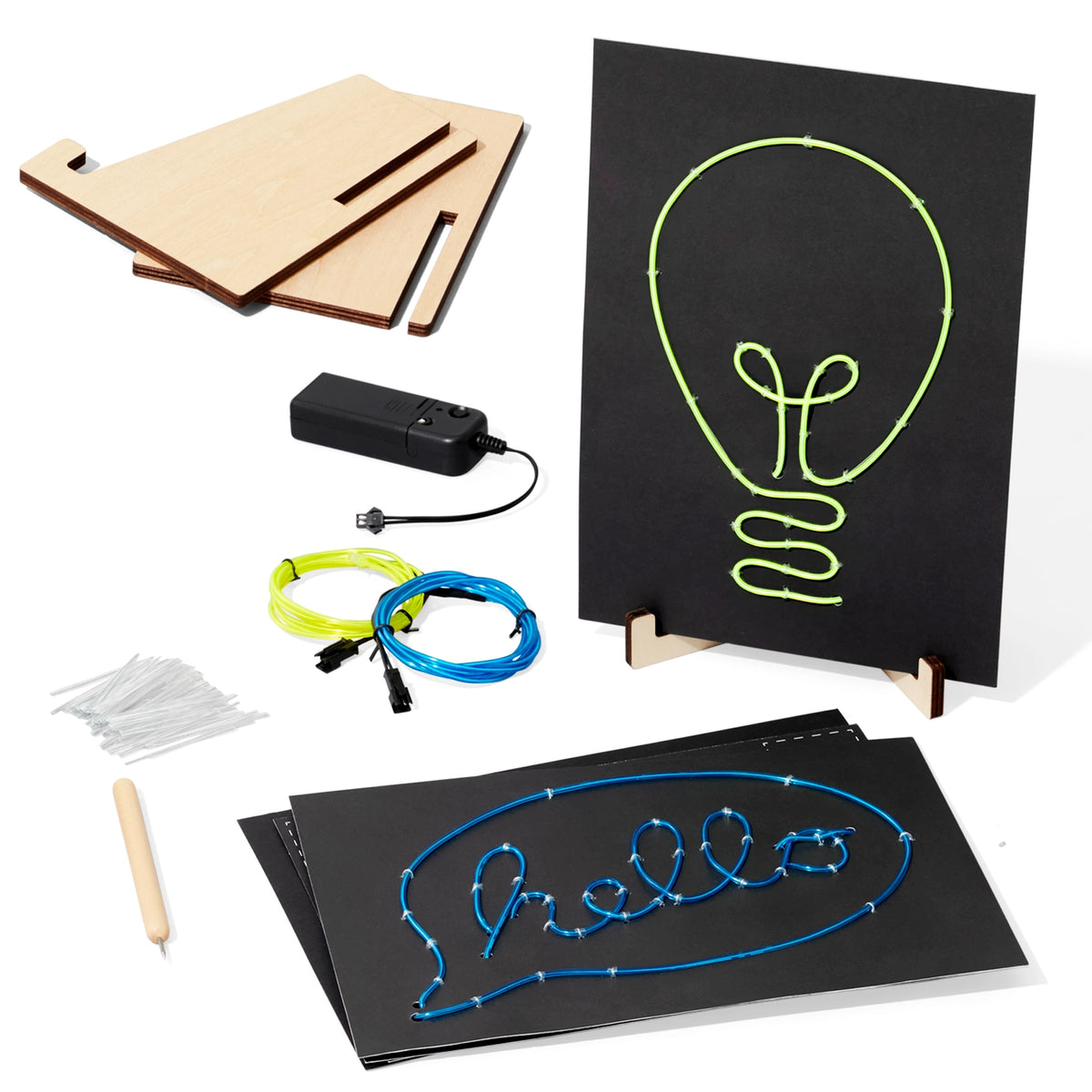 A collection of pieces shown on a hite background. At the top are two pieces for a wooden easel, some wire, an awl and to the left are two black light up signs, one with a neon yellow light bulb and one with a blue speech bubble with 'hello' in the center