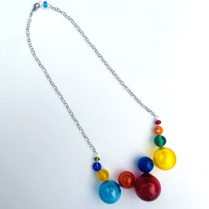 A silver chain necklace featuring a cluster of colorful glossy beads in red, orange, yellow, green, blue, and purple, displayed on a clean white background.