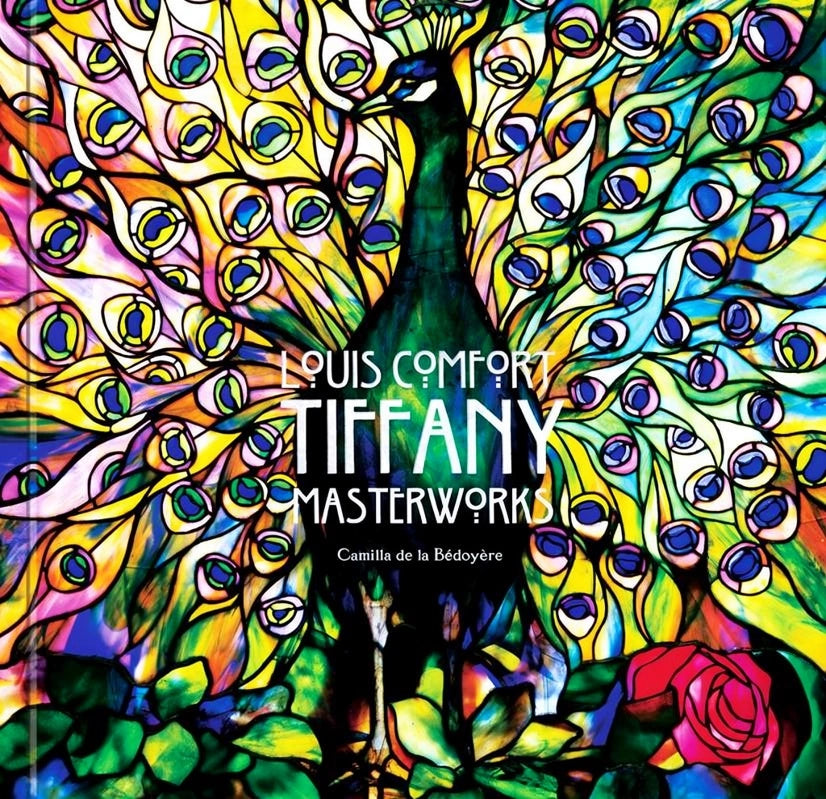 Book cover depicting a multi-color stained glass peacock and the words "Louis Comfort Tiffany Masterworks, Camilla de la Bedoyere" in the center