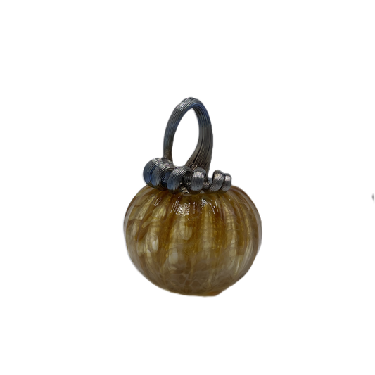 A small decorative glass pumpkin with a ribbed textured body in amber-brown and cream tones, featuring a dark blue-stem and loop handle, isolated on a white background.