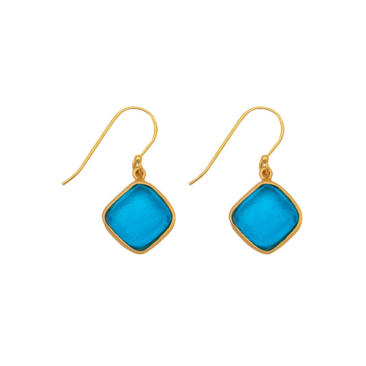 Gold earrings with blue glass on a white background