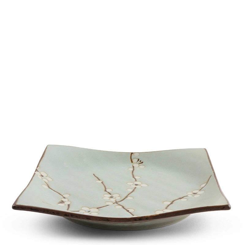 Soft blue square ceramic plate with white and brown floral design on a white background