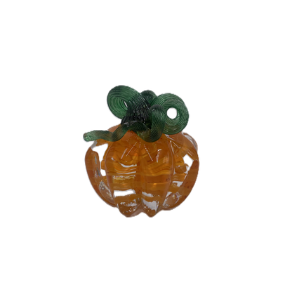 A glass pumpkin in translucent orange glass with a dark green stem, isolated on a plain white background.