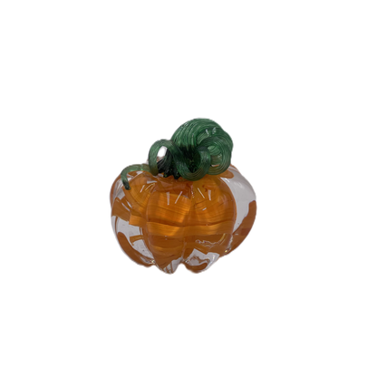 A glass pumpkin in translucent orange glass with a dark green stem, isolated on a plain white background.