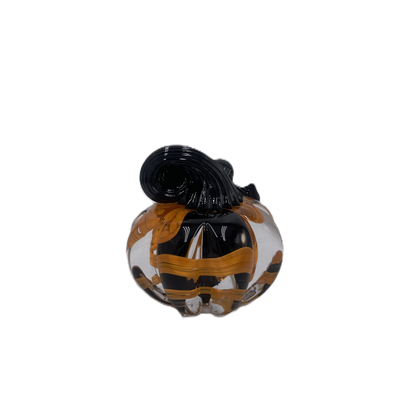 A solid glass pumpkin, featuring a glossy black stem and swirling orange, black and clear glass body on a plain white background.
