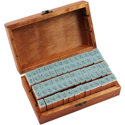 Wooden box with letter stamps on a white background