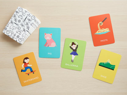 Colorful cards depicting small icons and the words "skateboard, pig, ballerina, pasta, shoe" on a light wood background.