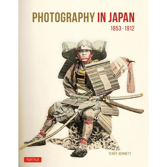 A beige bookcover with the words "Photography in Japan 1853-1912" featuing a seated samurai in full armor on a white background.