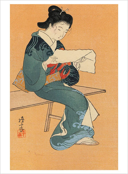 A Japanese woodblock print feauting a woman dressed in a blue kimono reading a piece of paper against a tan background.
