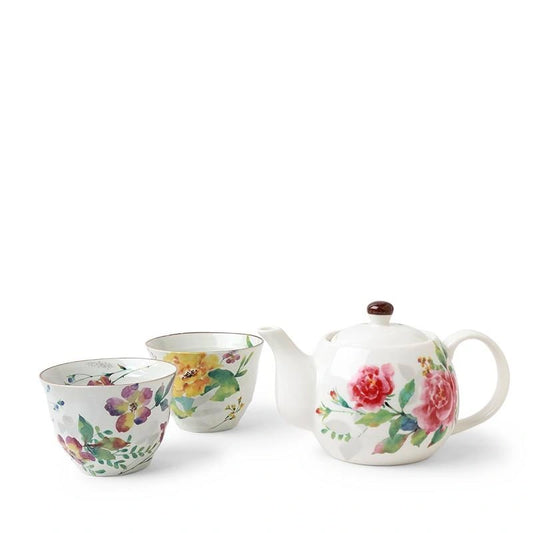 Tea set of one teapot and two tea cups with floral designs on a white background