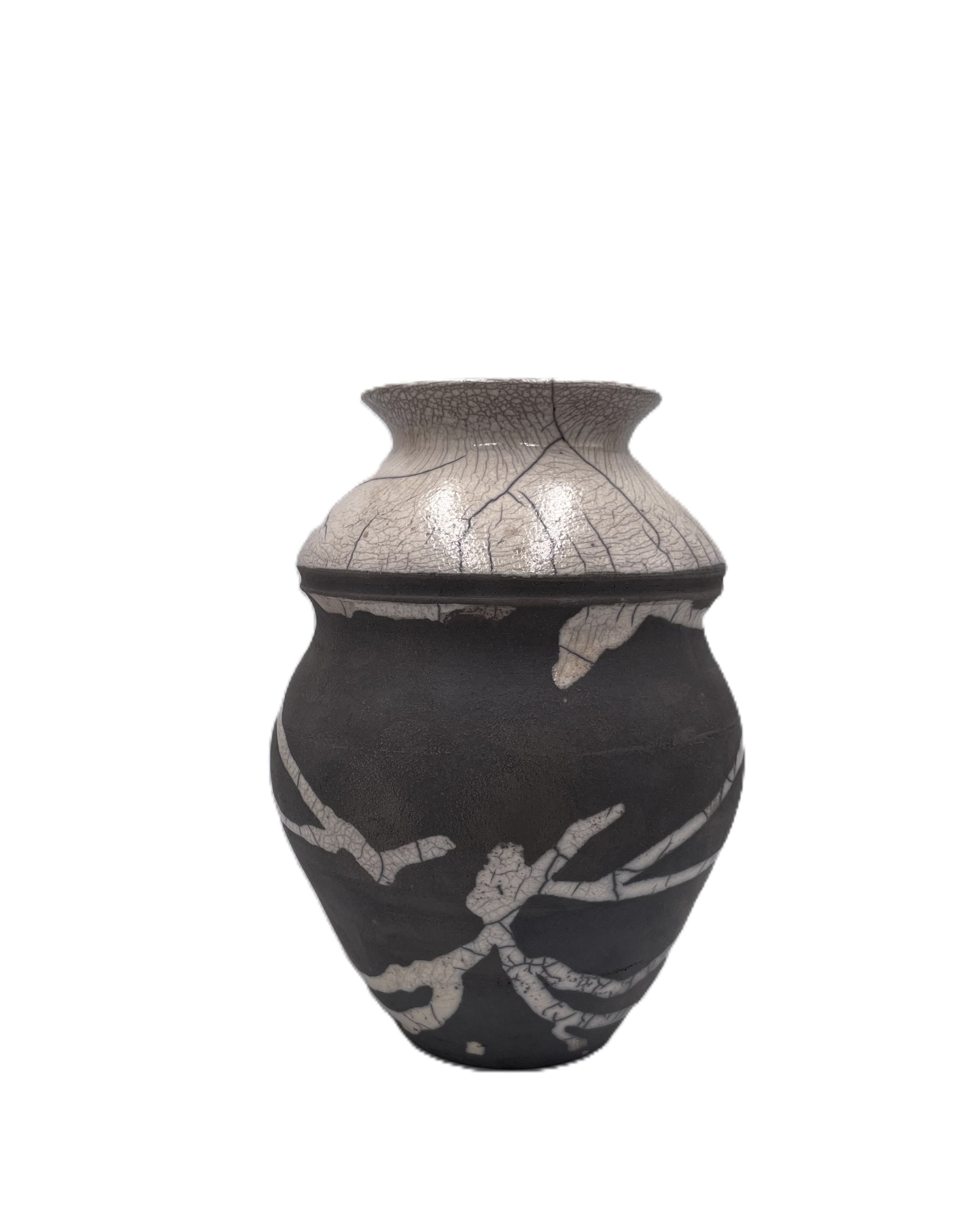 Decorative ceramic vessel with black and cream raku design on a white background
