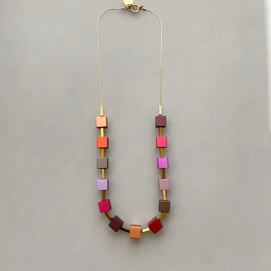 Necklace with colorful square beads on a gray background