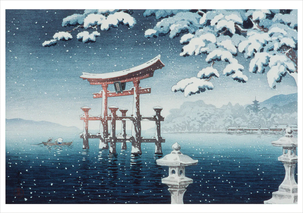 Traditional Japanese gate (torii) in a snowy landscape with water and mountains.