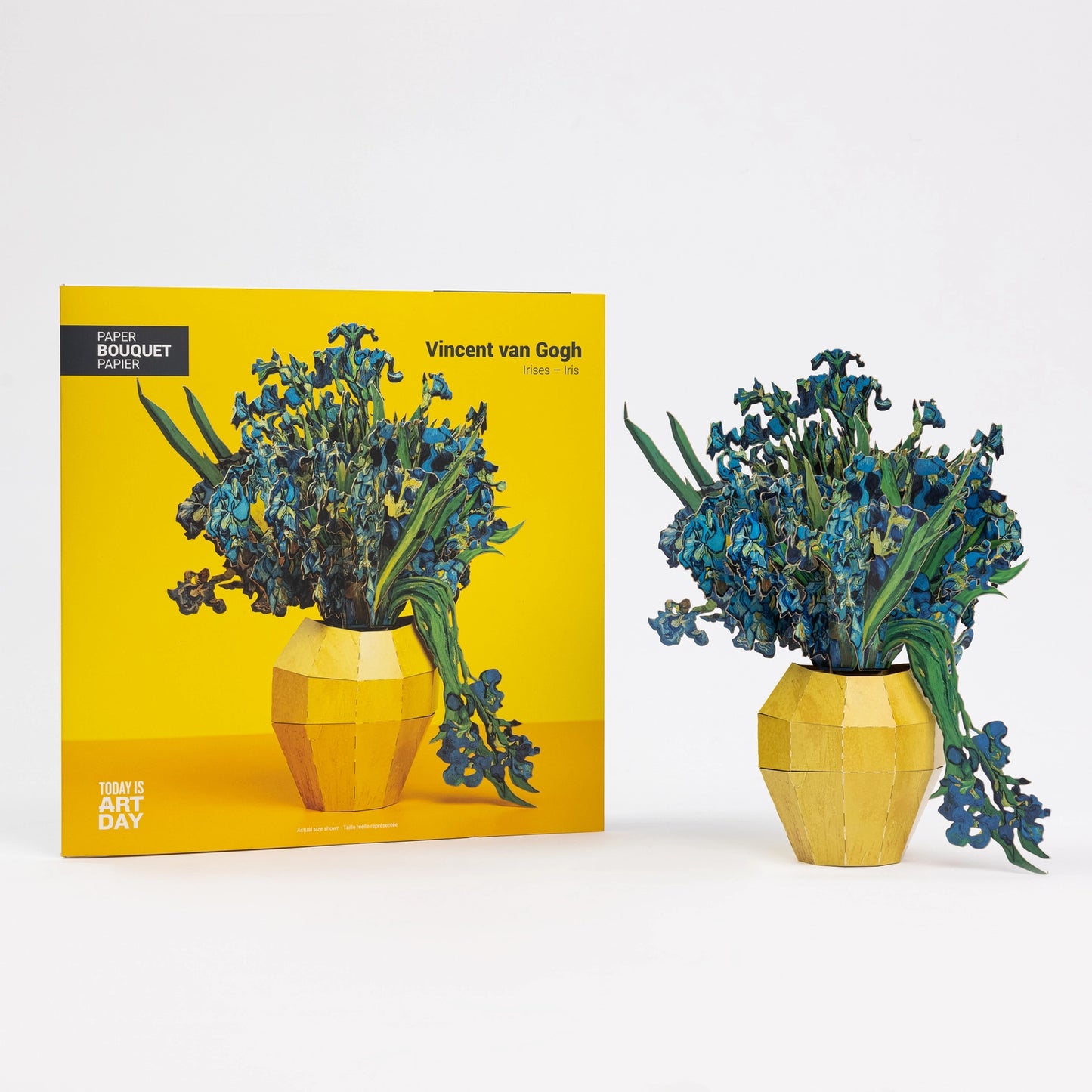 Paper bouquet of blue flowers in a yellow vase next to its packaging with Van Gogh design.